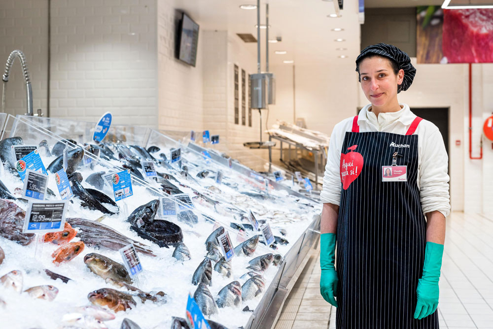 Auchan Team member next to fresh fish